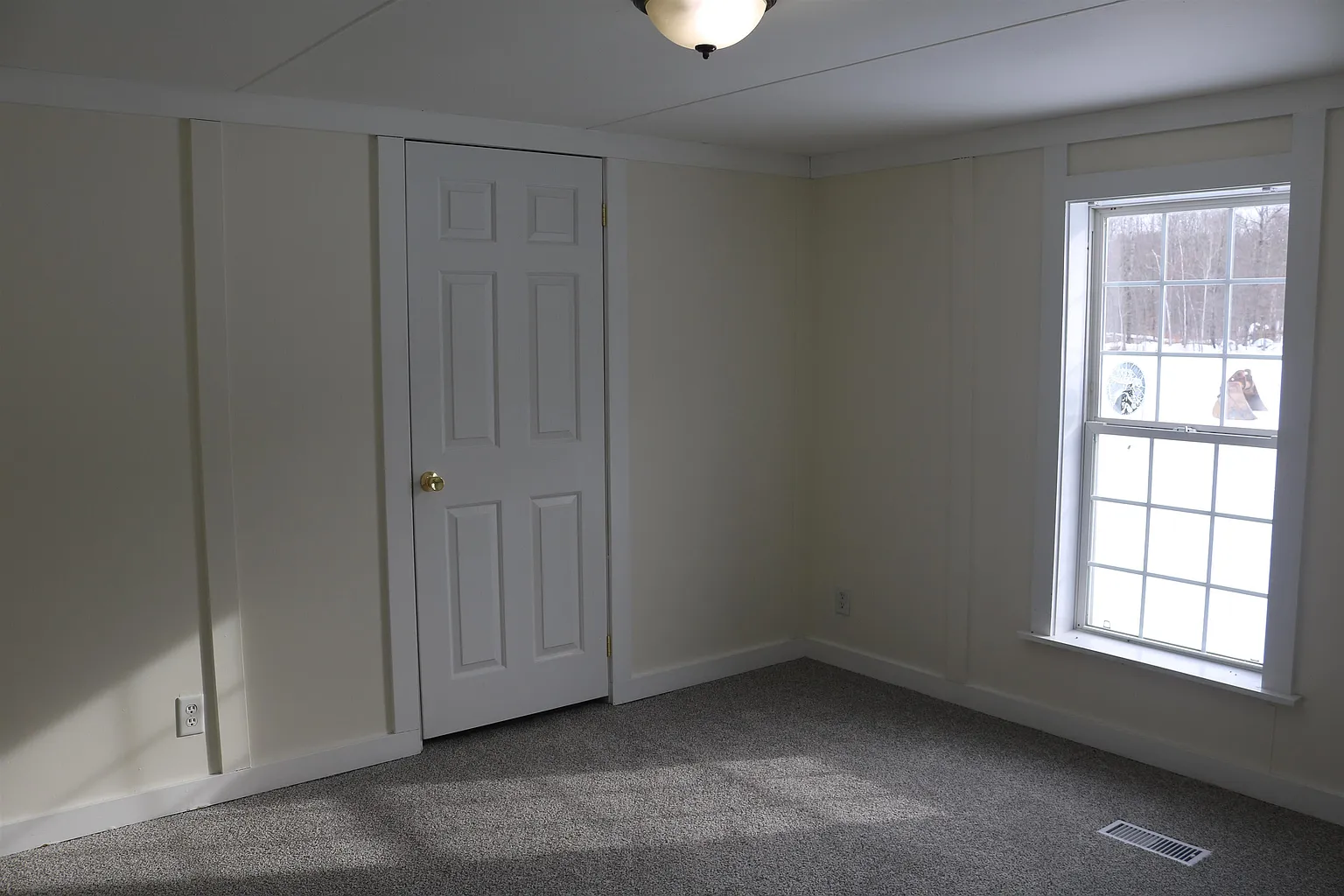 Carpeted bedroom with closet