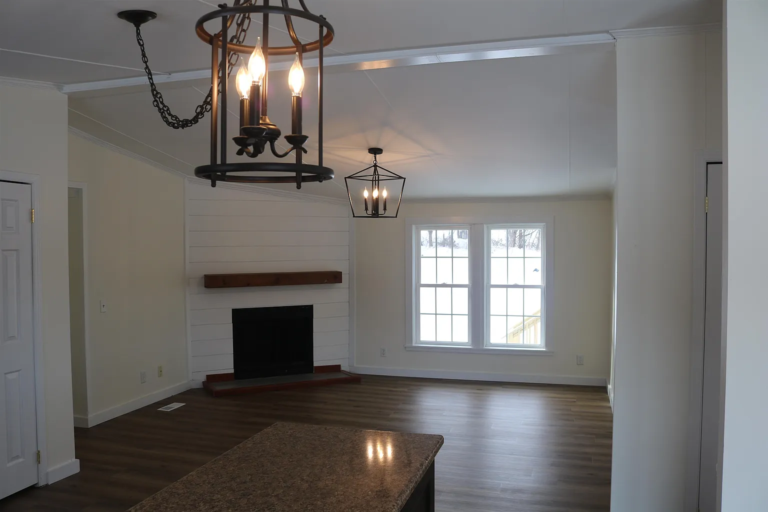 Living room with fireplace and front windows