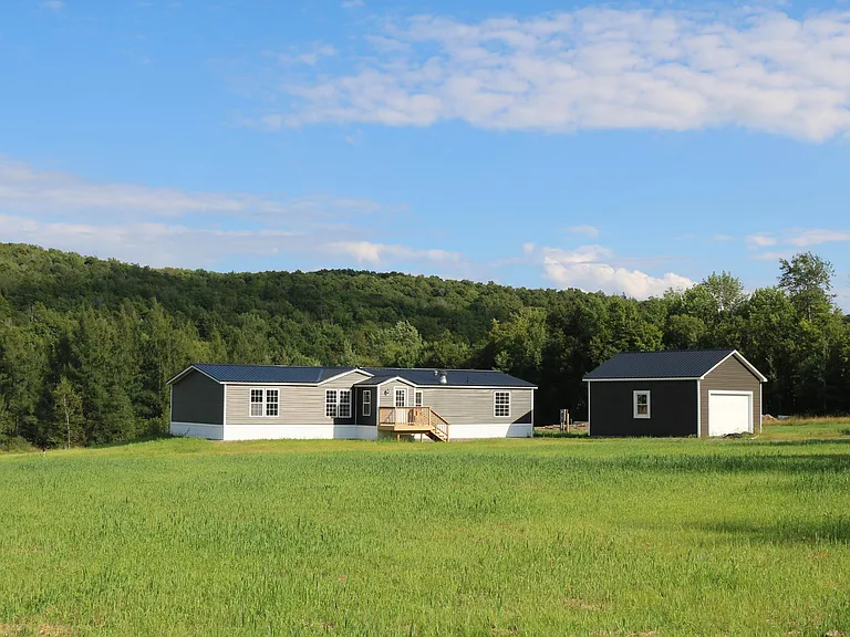 Wide view of the home and detached garage