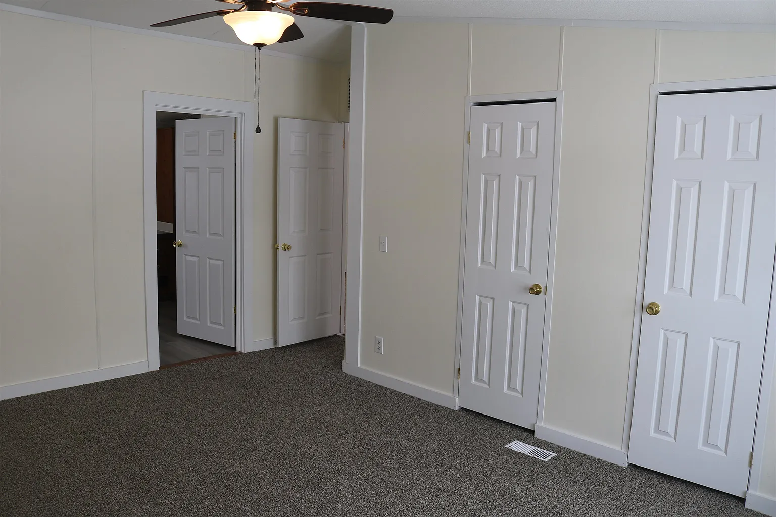 Carpeted room with closets